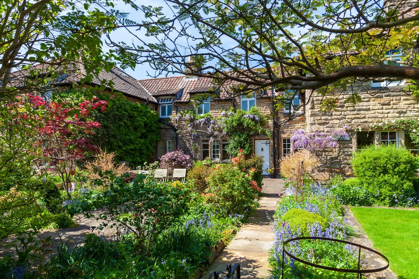Cottage garden with full planting and stone path